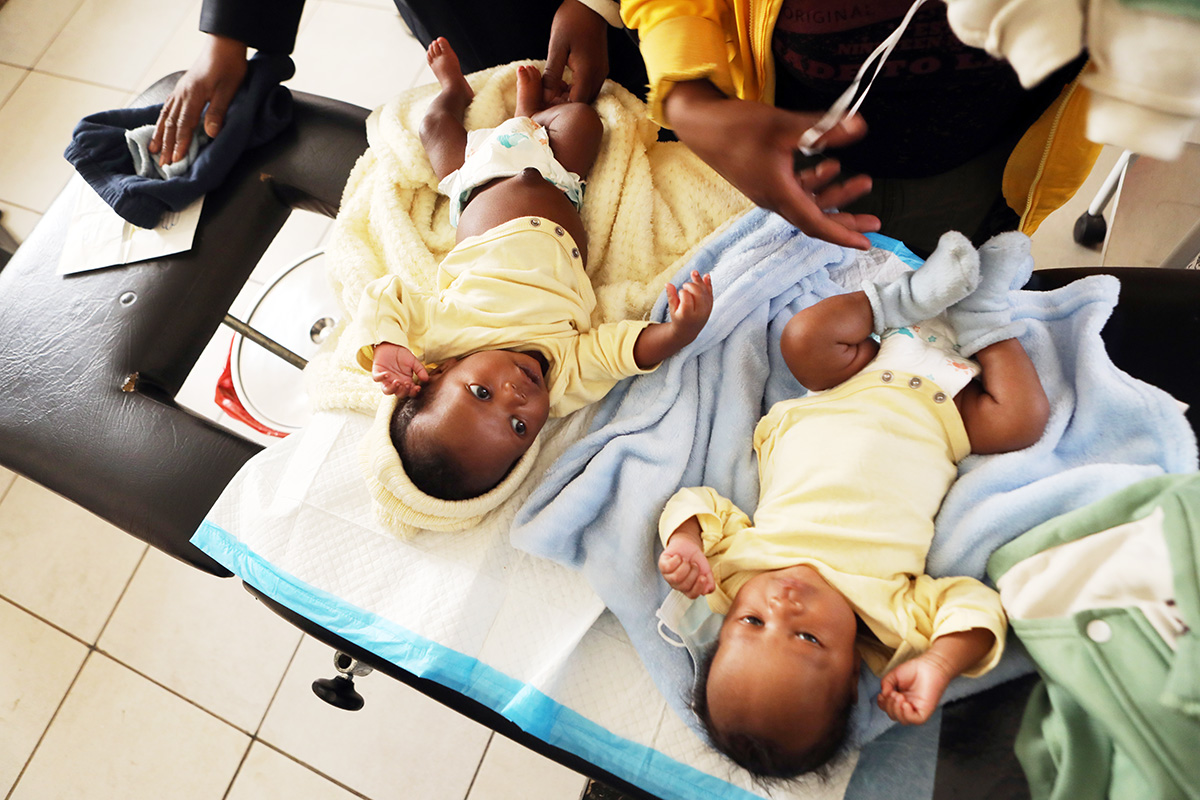 Nurse in charge Maleshoane Seleke conducts a pediatric checkup for Mohliehi Mohlalisi’s twin babies at PIH-supported Lebakeng Health Center.
