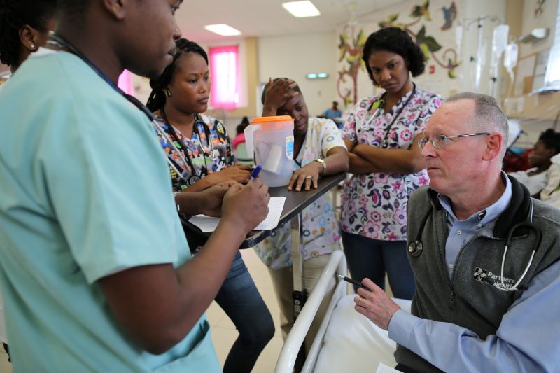 Paul Farmer speaks with pediatric residents at Hopital Universitaire de Mirebalais in Haiti