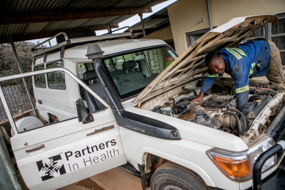 William Owen, a driver and mechanic for PIH in Malawi, checks on the health of one of his team’s SUVs.