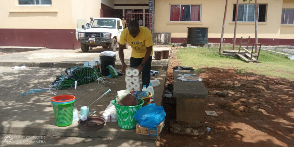 Melvin Tamba of PIH Liberia sorts supplies for the quarantine center