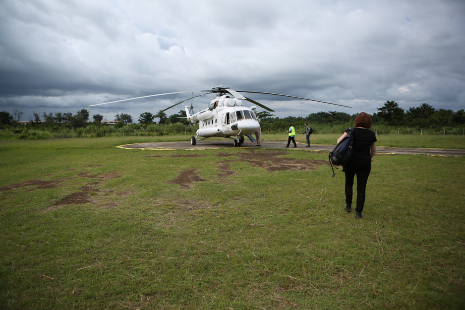 Sheila Davis walks to a helicopter during Ebola response in Liberia