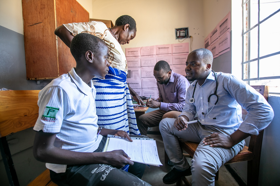 Kerefasi Wiliyamu, 14, talks with clinical officers at the Advanced NCD Clinic