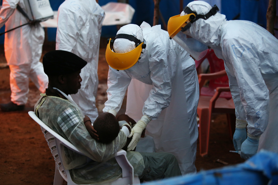 patients arrive at night to an Ebola treatment unit in Sierra Leone
