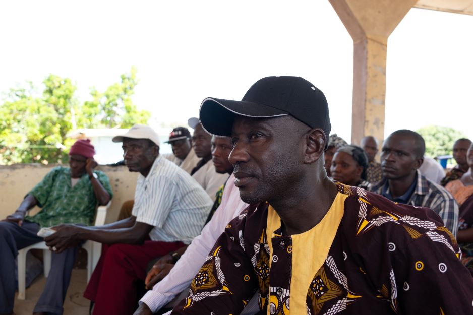 A resident of Soa Chiefdom listens to the presentation