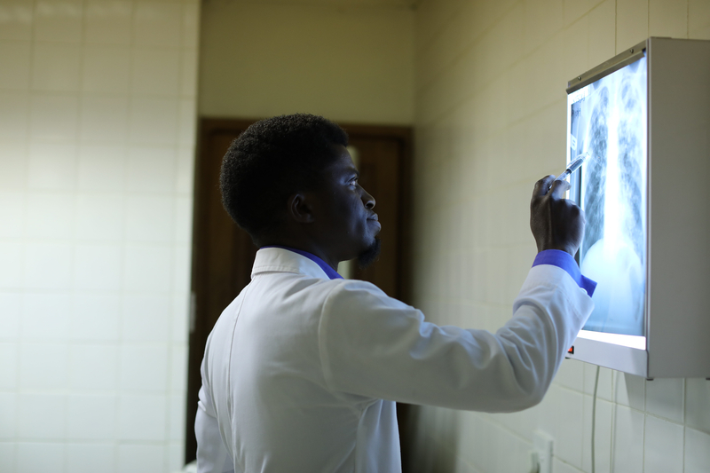 doctor reviews images of lungs from tuberculosis patient in Lesotho