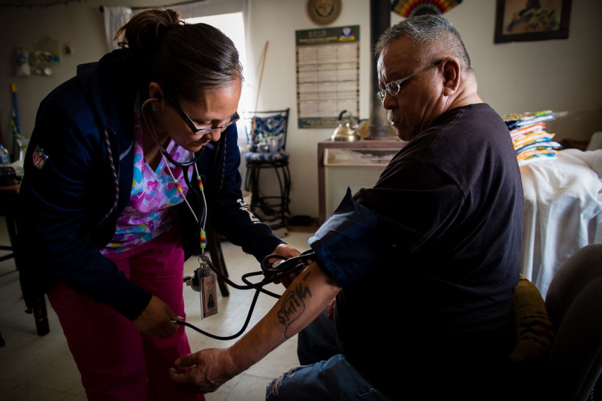 Community health representative on Navajo Nation takes patient's blood pressure