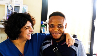Dr. Marta Patiño and James Fatoma share a moment in the emergency ward at Koidu Government Hospital in Kono, Sierra Leone.