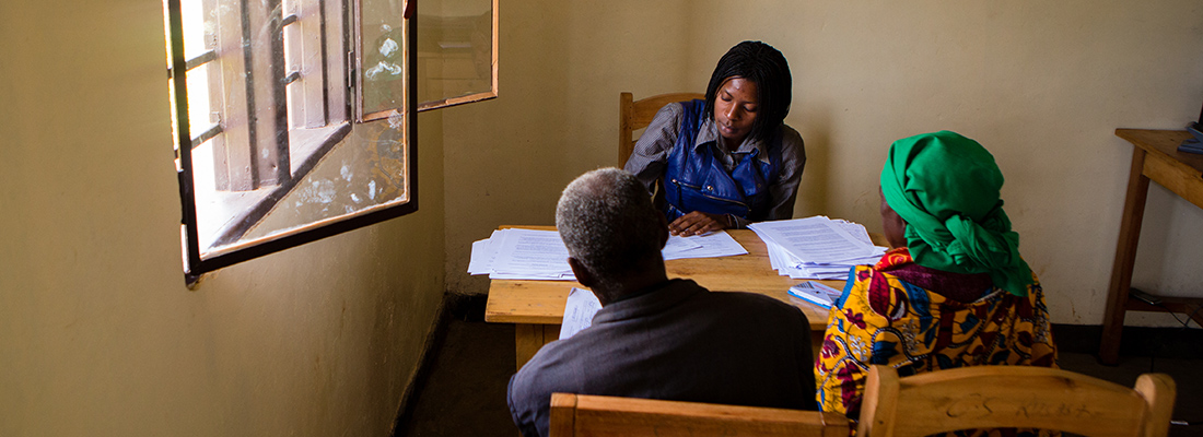 woman talking to two people at desk