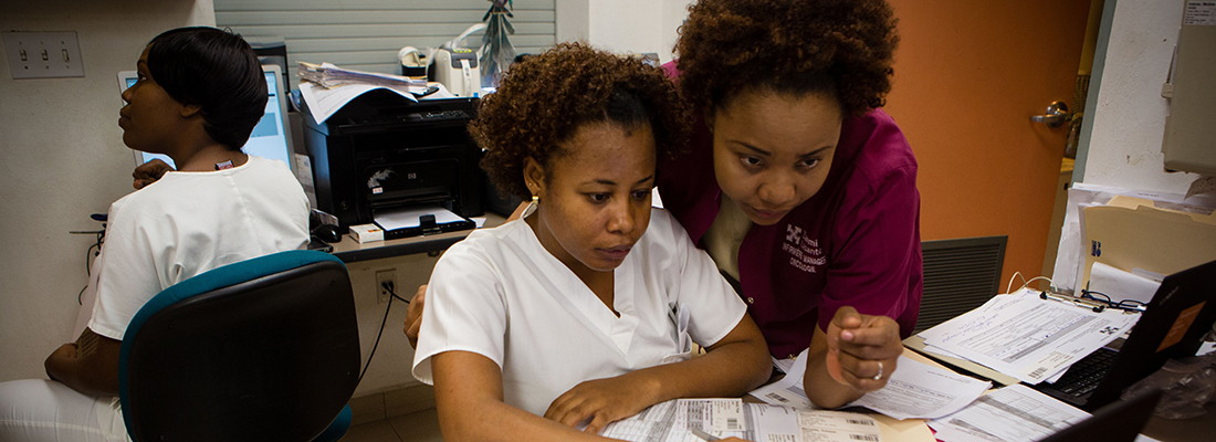 Nurses reviewing news on the screen