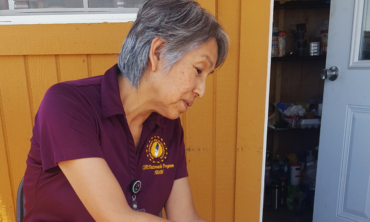 woman looking down next to food pantry