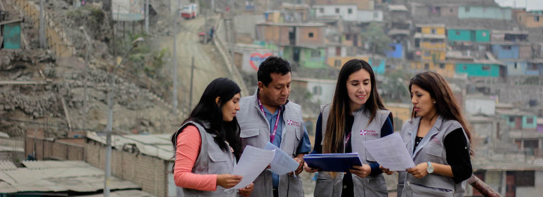 community health worker in Peru discussing and looking over notes