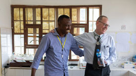 Dr. Paul Farmer sharing a friendly moment with one of his staff.