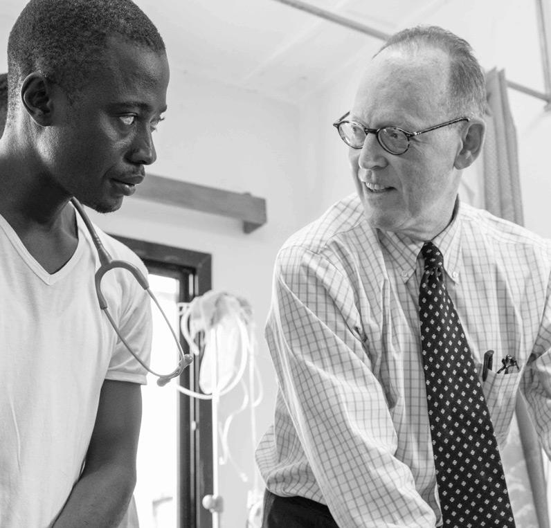Dr Paul Farmer in conversation with a fellow clinician in Sierra Leone