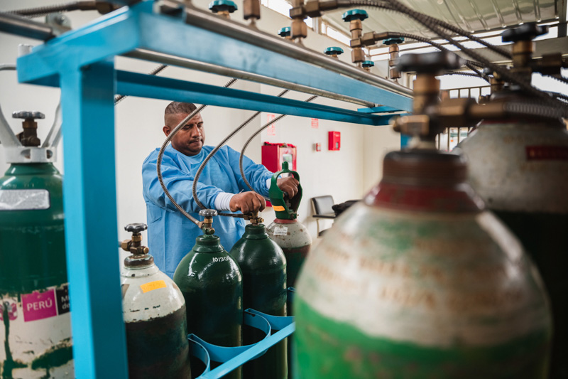 Juan Hurtado, medical staff at the San José de Chincha Hospital, does routine maintenance and inspection work on the medical oxygen systems of the oxygen plant