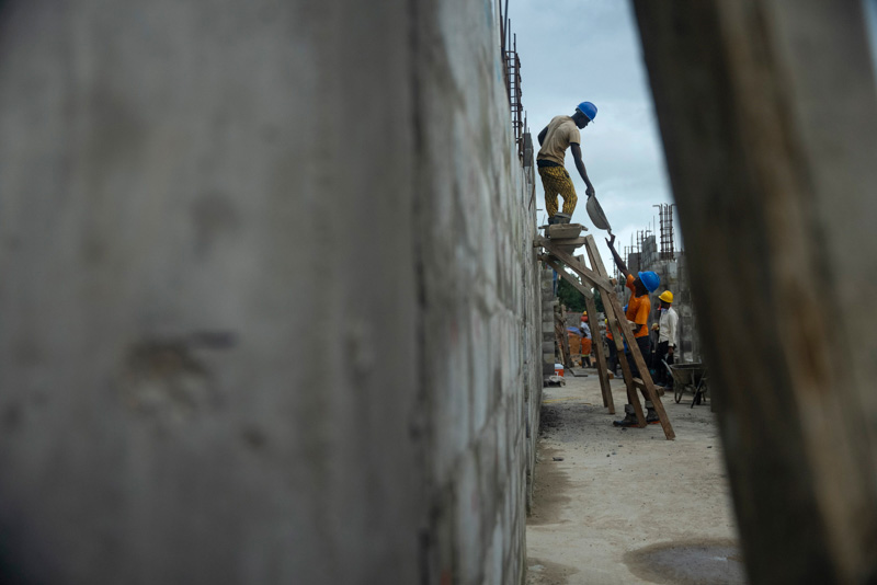 Construction workers build conder block walls at the Maternal Center of Excellence in Kono, Sierra Leone