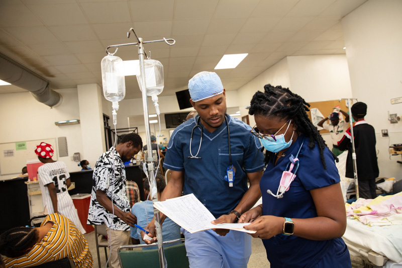 Clinicians review a patient's chart at Hopital Universitaire de Mirebalais in Mirebalais, Haiti, on March 24, 2023