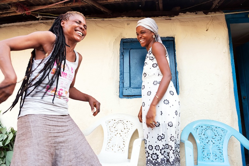 Women celebrate outside their home in Sierra Leone