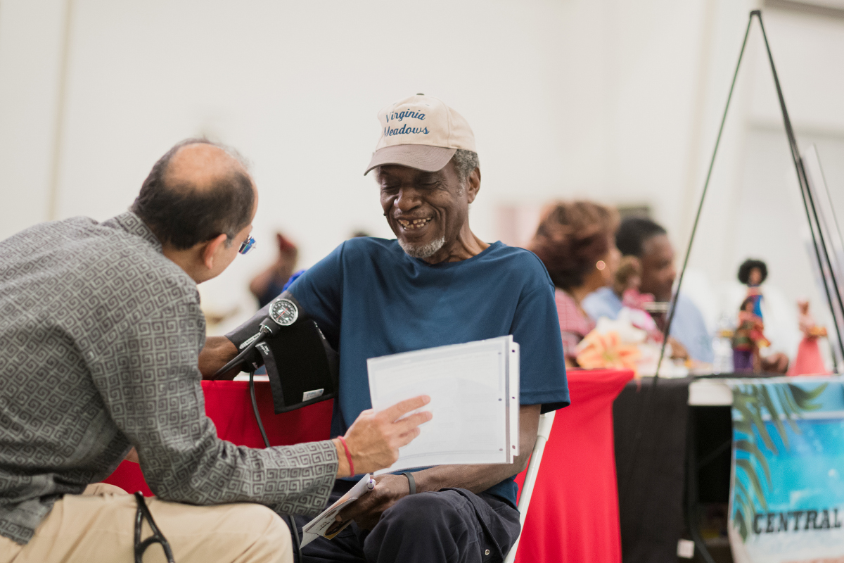 A Montgomery resident speaks to a doctor at the 2024 Heritage and Health Day.