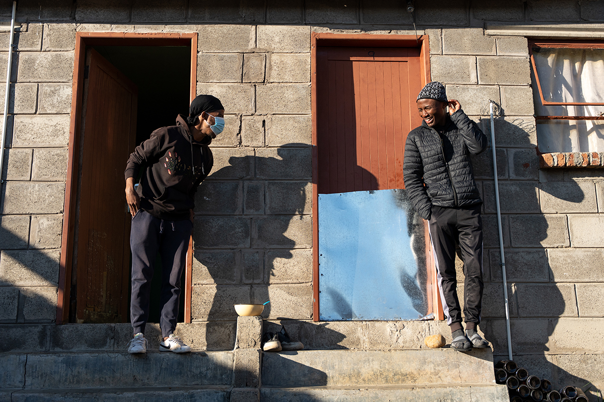 Sefonthoane Mohohla, 26, with his friend and neighbor, Kaemane Makhetha, who is his treatment supporter. 