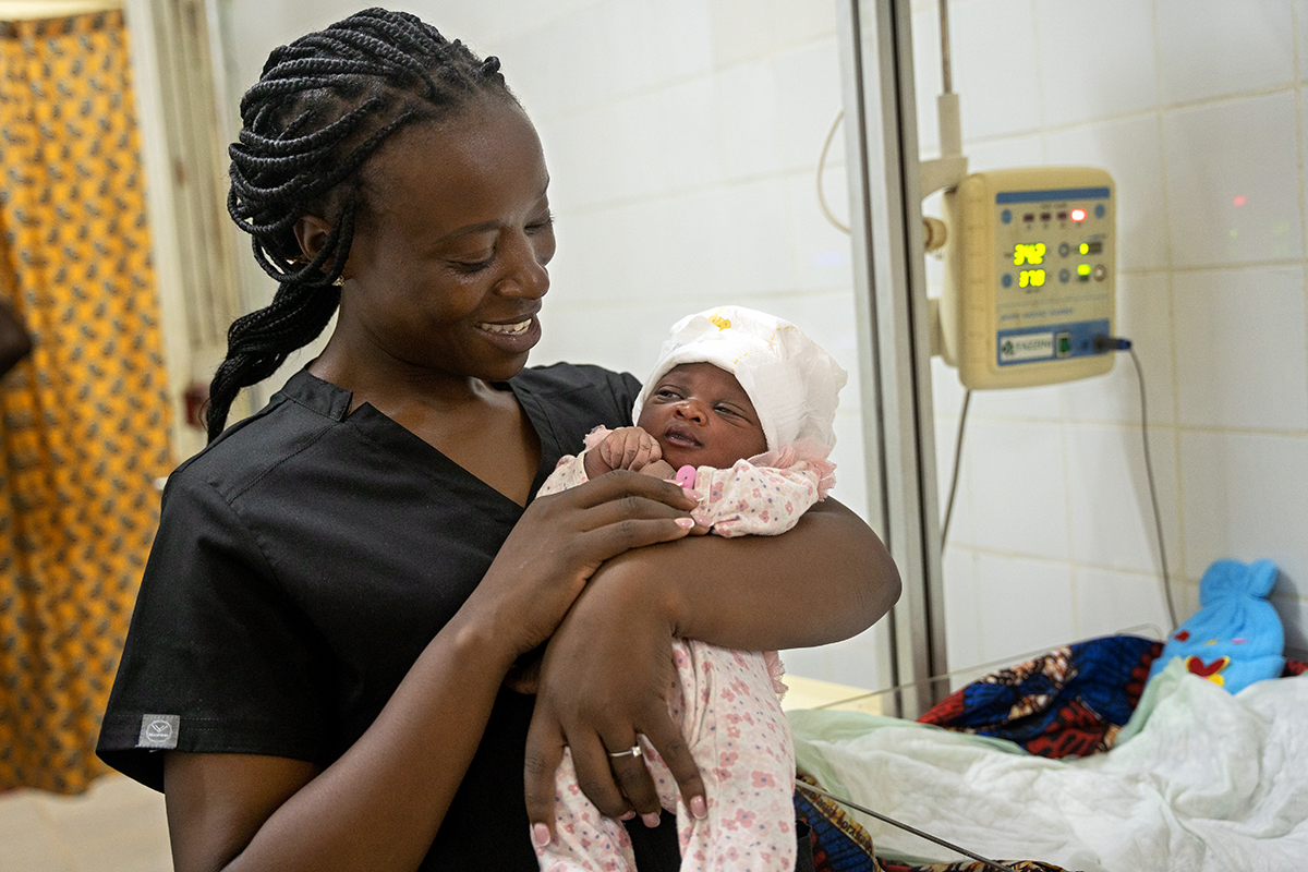 Evaline Ngige holds a baby Sia Mabinti Adebuba