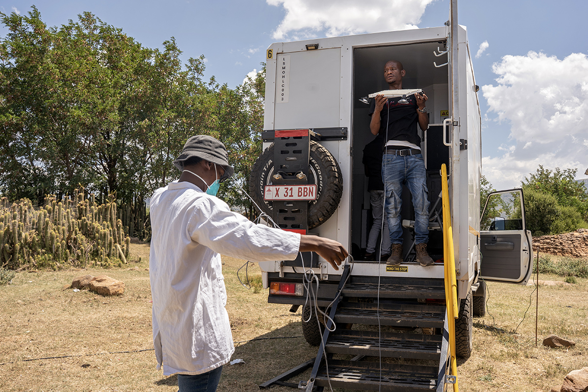 PIH's Nkosana September (right) and Ts'epo Ts'umane (left), a lab technician, by the mobile X-ray truck