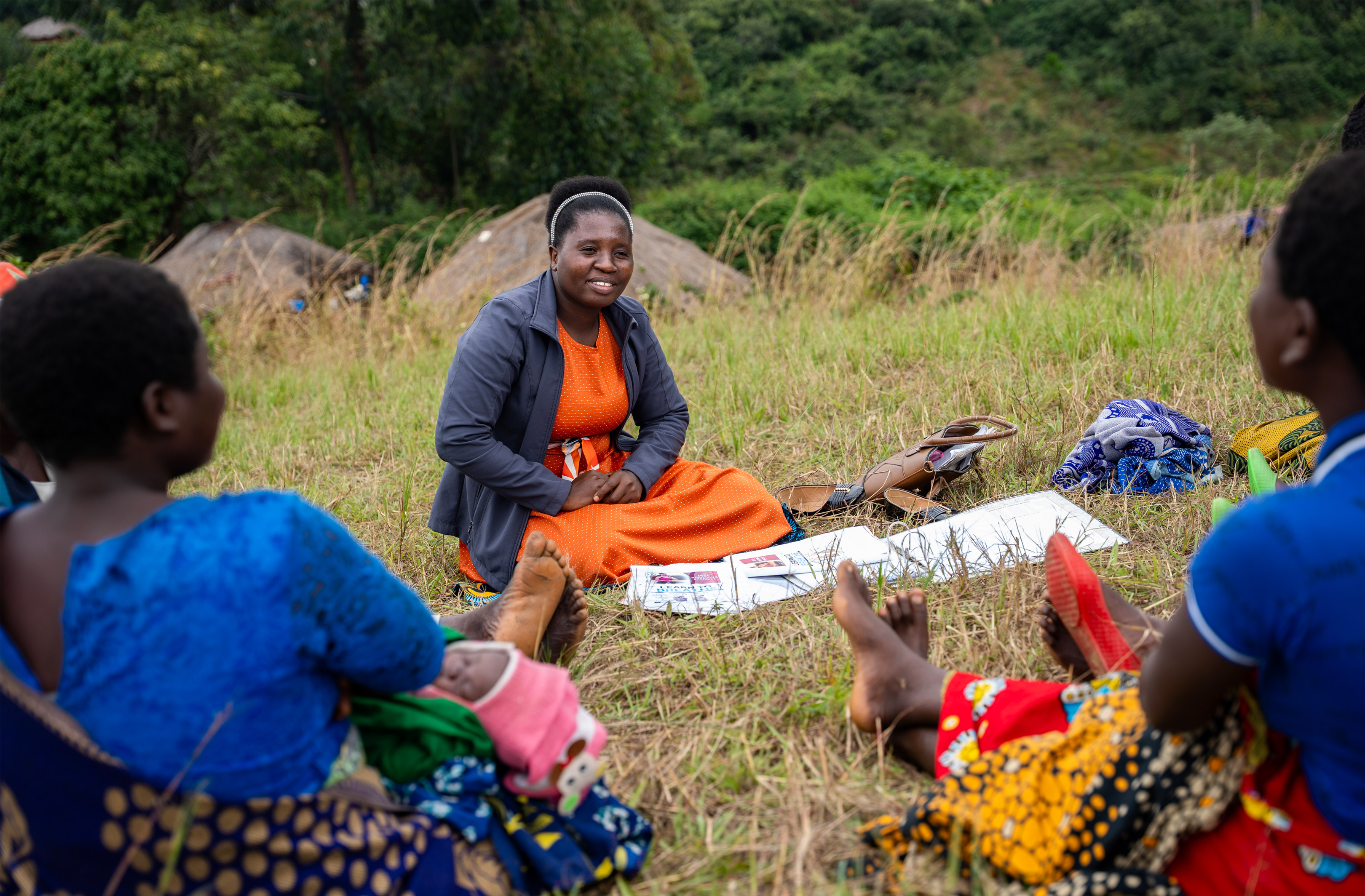 CHW with patients in Malawi