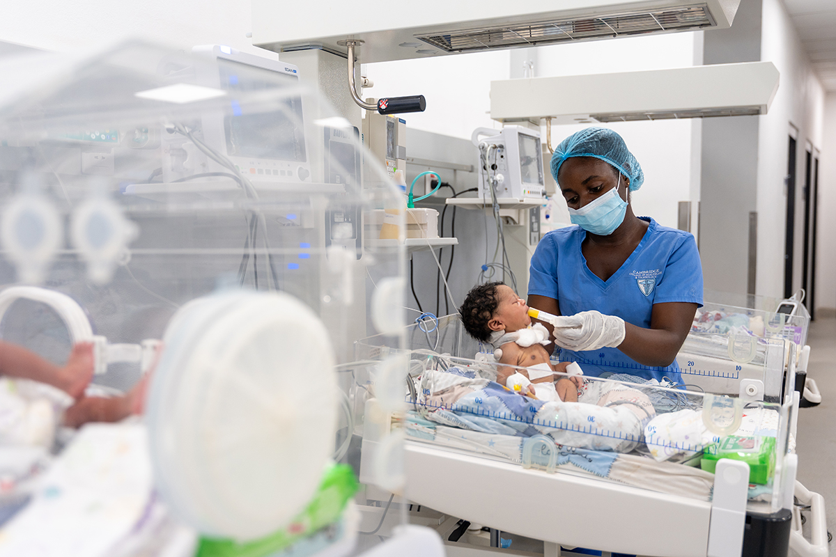 Nurse Danielle Jabati feeds a baby in the NICU