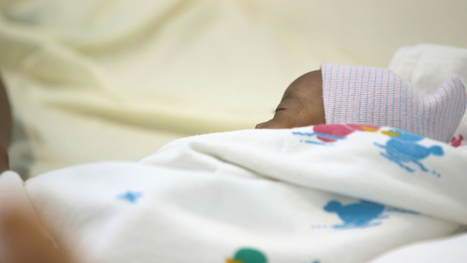 A newborn rests and receives care at PIH-supported University Hospital in Mirebalais, Haiti, where there are pediatric and neonatal intensive care units.