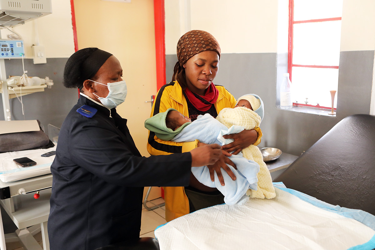 Nurse in charge Maleshoane Seleke conducts a pediatric checkup for Mohliehi Mohlalisi’s twin babies.