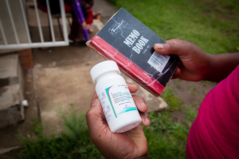 bottle of antiretroviral medication and daily journal