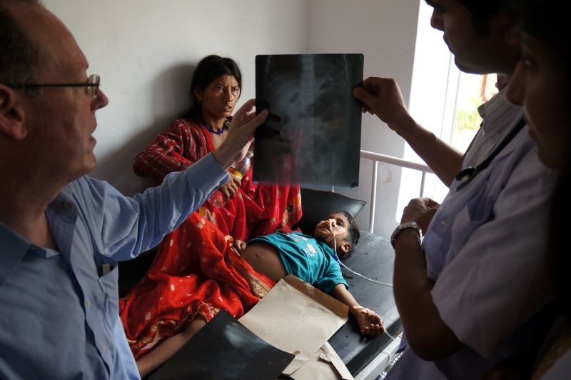 Paul Farmer reviews an xray of a patient in Nepal