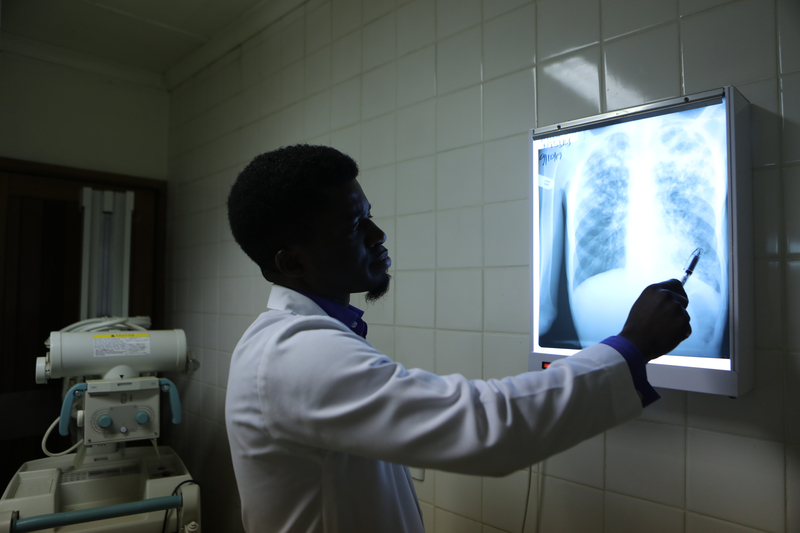 doctor points to patient's X-ray 