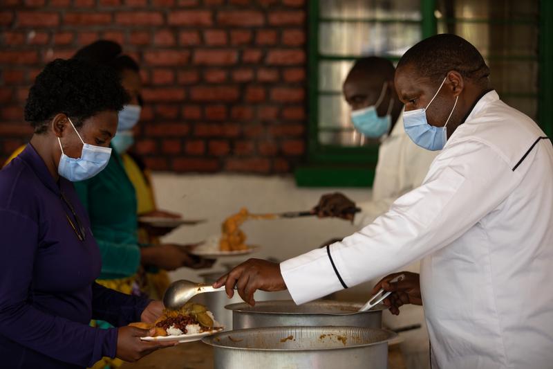 Head Chef Tugirumugisha Raymond serves food to patients and staff at Butaro District Hospital in Rwanda. Photo by Zack DeClerck / PIH.