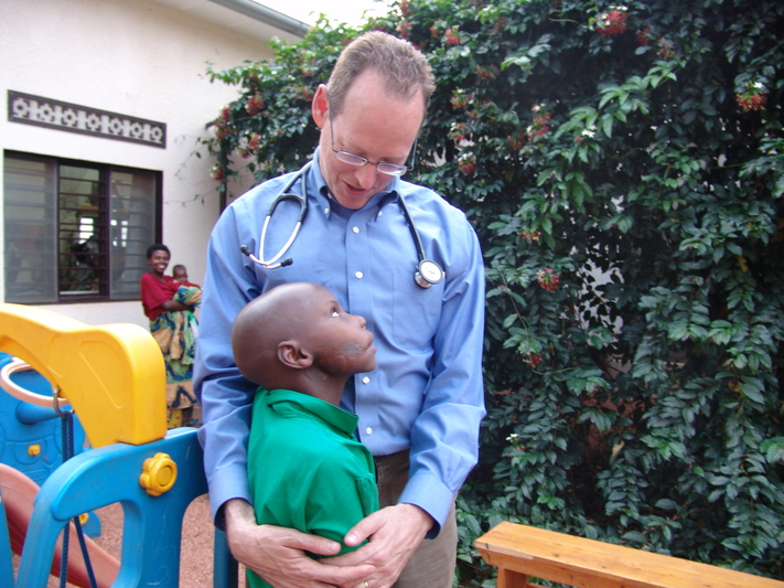 Dr. Paul Farmer with a young patient in Rwanda. Photo by Laurie Wen for Partners In Health.
