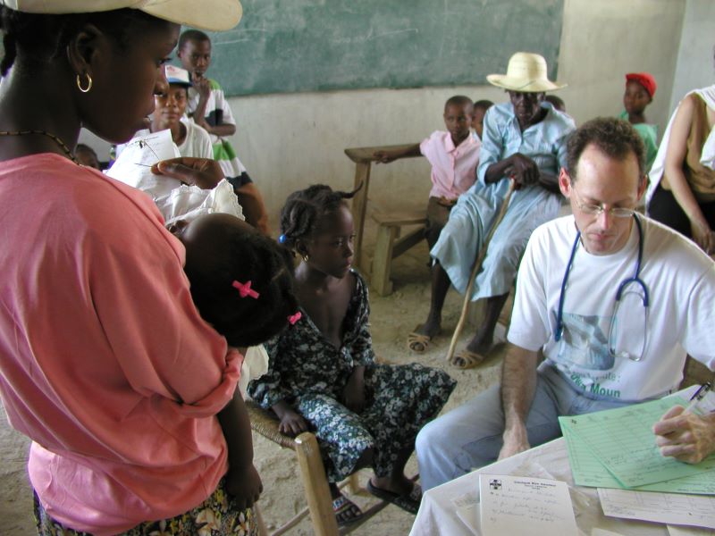 Paul Farmer tends to patients in clinic in Haiti
