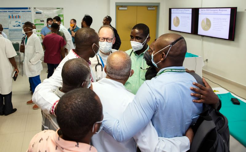 Paul Farmer embraces clinicians at University Hospital in Mirebalais, Haiti