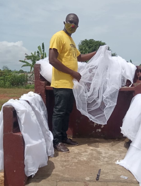 Melvin Tamba prepares mosquito nets for the center