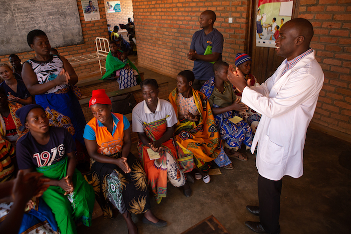 Doctor wearing a mask examining a patient