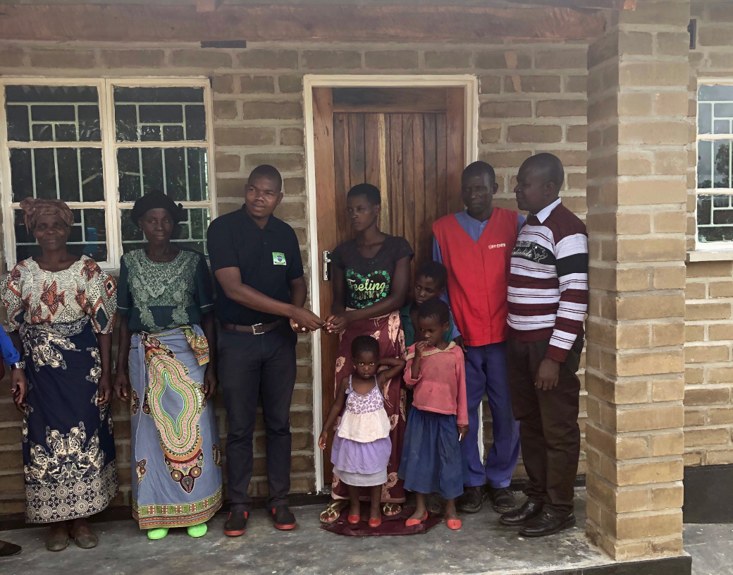 Rose Kapeni and her children at their new home, February 2019 in Neno
