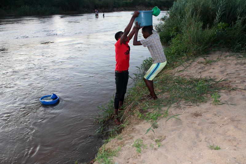 The community surrounding Neno District uses the Lisungwi River to draw water for domestic use.