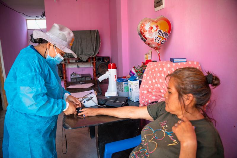 Meysi Mendoza during a home visit with community health worker Elizabeth Anchante. Photo by Monica Mendoza / Partners In Health.