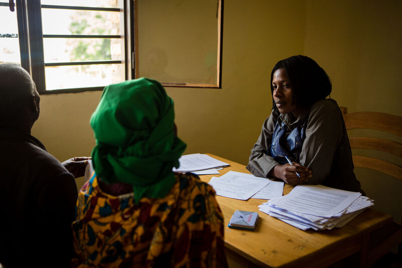 a PIH mental health coordinator speaks with a patient in rural Rwanda
