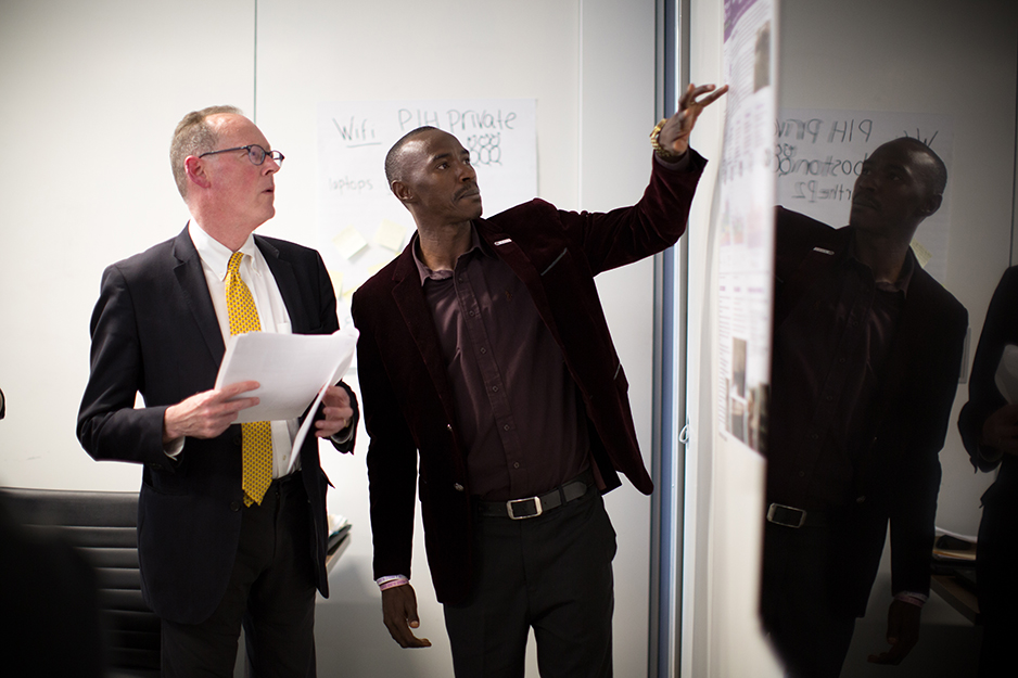 Musa Bangura, Laboratory Manager in Sierra Leone, presents before PIH co-founder Dr. Paul Farmer participates in a roundtable discussion with PIH lab staff visiting Boston from nine different  countries.