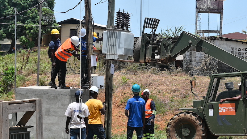 construction workers unmount old transformer
