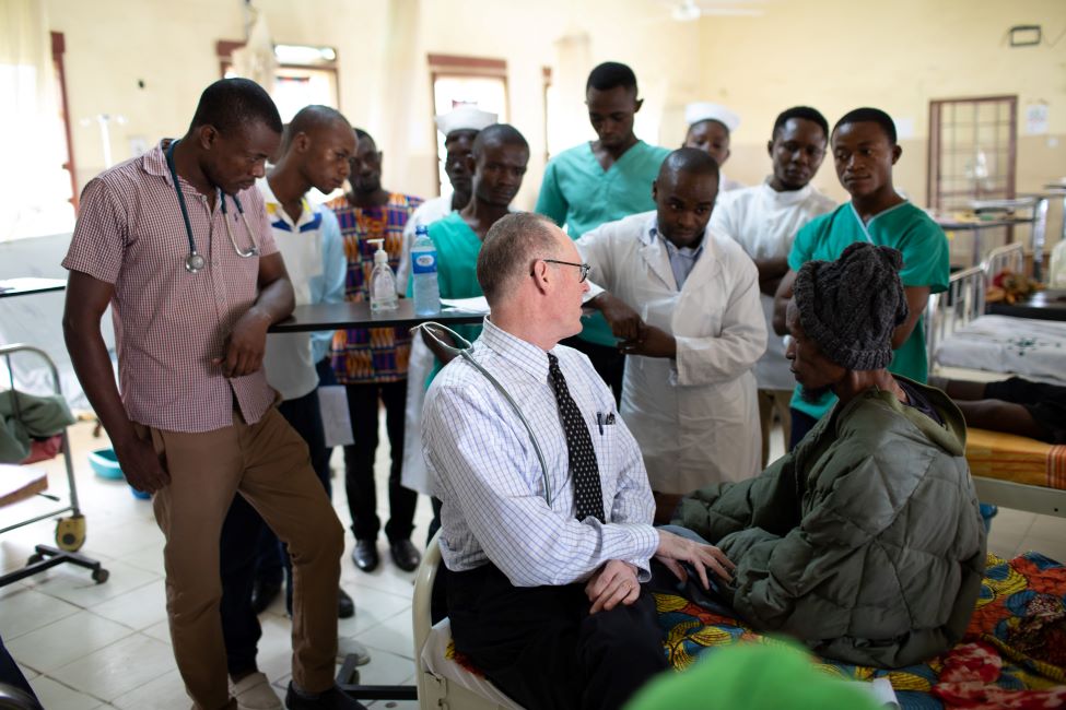 Dr. Farmer with Jalloh, clinical staff, and medical students