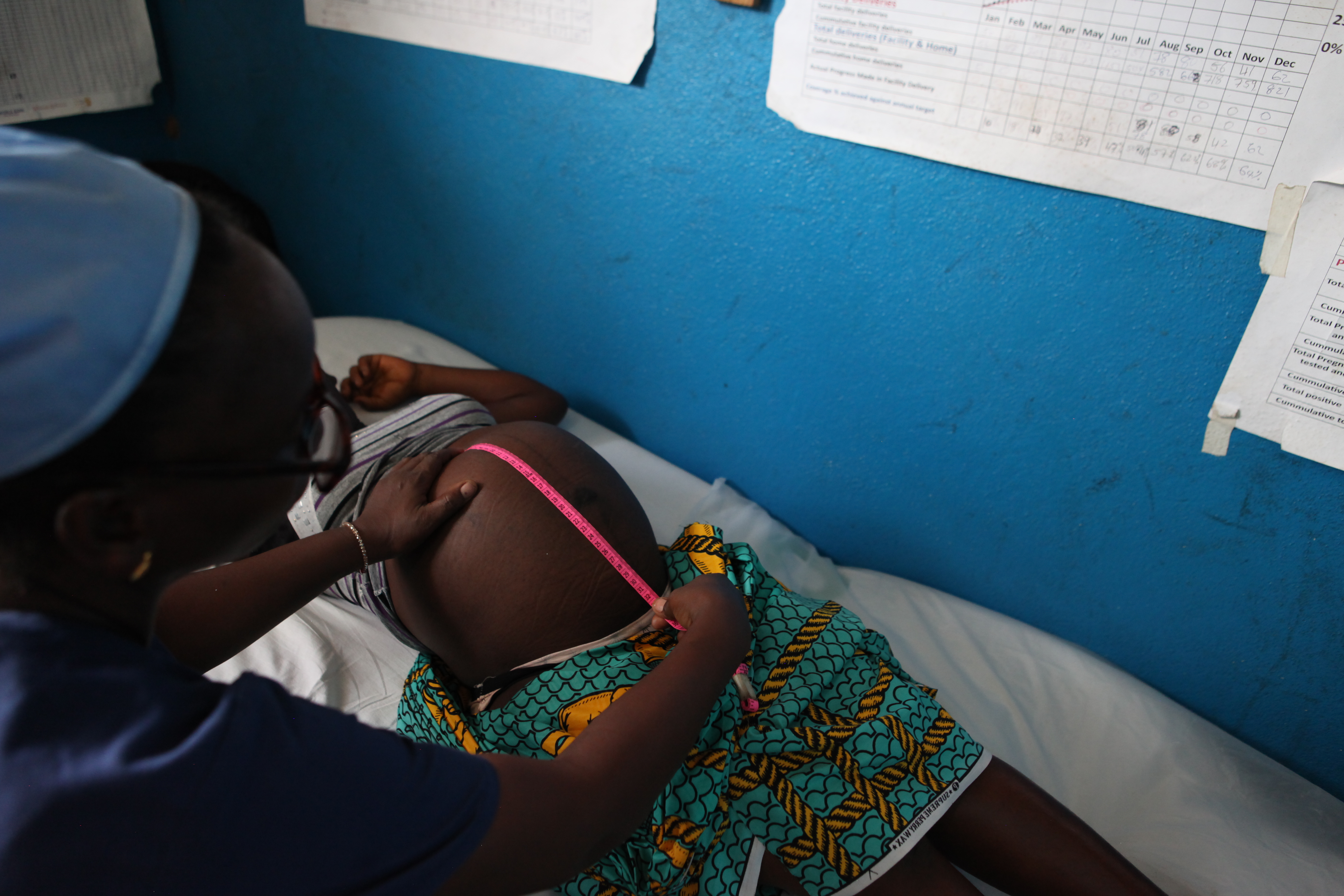 midwife takes measurements during a prenatal checkup