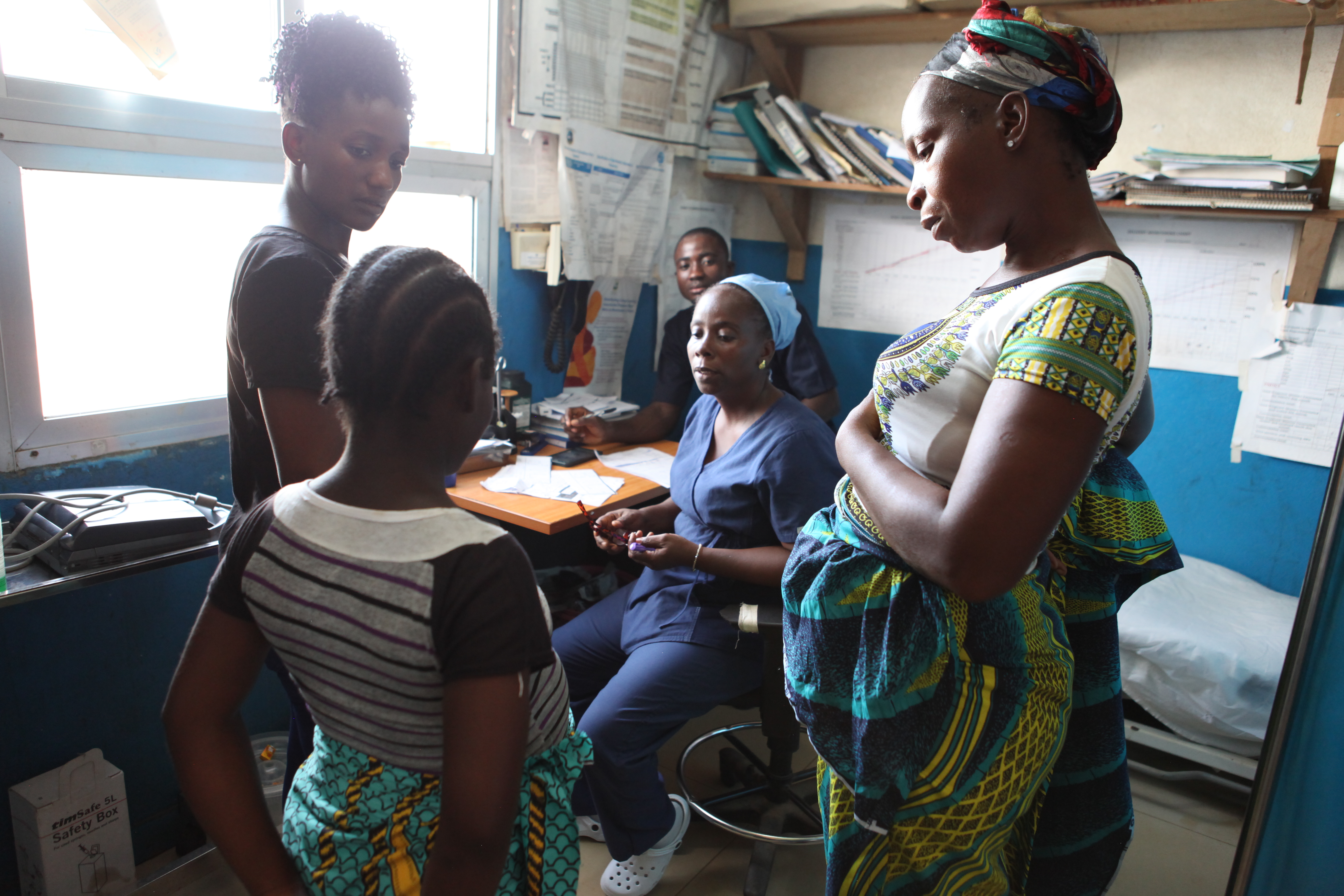 midwife consults with patient following a prenatal checkup