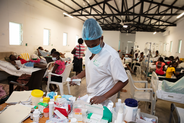 Clinicians work with sick patients at a Cholera Treatment Unit at Hôpital Universitaire de Mirebalais (HUM) in Mirebalais, Haiti. Photographed Dec. 14, 2022 by Nadia Todres f