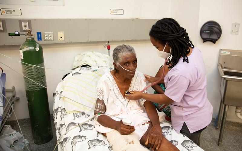Marianne Melissa  being checked on by a clinician. She was hit by a tap trap in Beladaire. She is from Carrefour and was brought by ambulance to Mirebalais from Beladaire. 