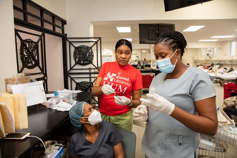 The ER at HUM. Morning rounds with clinicans, led by Dr. Cassandra Edmond...Hopital Universitaire de Mirebalais (HUM) in Mirebalais, Haiti, on March 24, 2023. Photos by Nadia Todres for PIH. Dark grey : Nurse Herline Dorlis Light  Grey : Nurse Bertide Louis Jeune Red shirt : Nadège Descartes. Nurse assistant.  The ER at HUM. Morning rounds with clinicans, led by Dr. Cassandra Edmond...Hopital Universitaire de Mirebalais (HUM) in Mirebalais, Haiti, on March 24, 2023. Photos by Nadia Todres for PIH.
